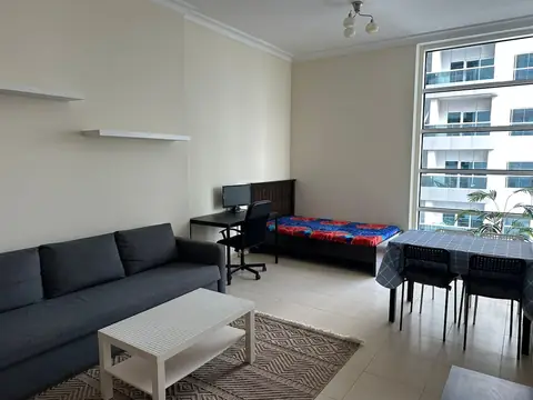 Bright living room with sofa, dining area and smart TV